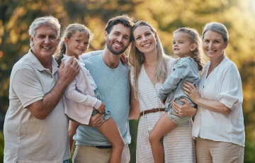 Family smiling together with healthy, beautiful smiles