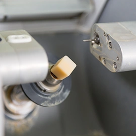 Close-up of CEREC technology milling a ceramic crown